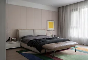 A modern minimalist bedroom with a bed, carpet, window, and artwork.