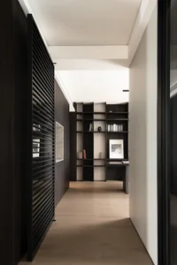 A modern office library featuring wooden paneling and glass shelving.