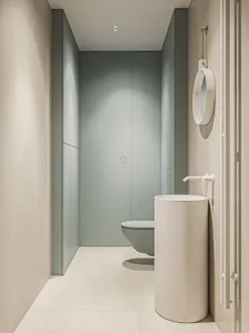 A modern, compact bathroom with a ceramic floor and minimalist design.