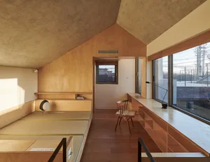 A modern living room with wooden furniture and large windows.