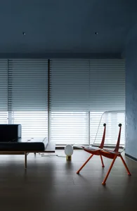 Modern living room with glass chairs and a large window.