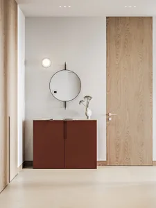 Minimalist modern interior design featuring a sleek wooden cabinet, round mirror, and minimal decor.