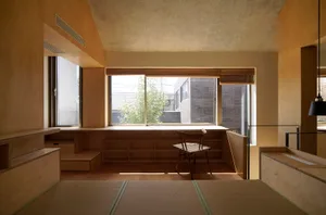 A minimalist room with wooden and bamboo materials, a large window, and a wooden chair.