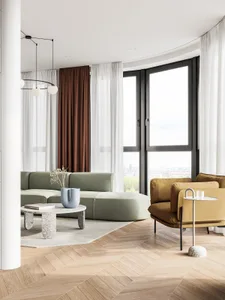 A modern minimalist living room with a curved sofa, armchair, and marble coffee table.