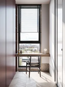 A modern office space with large windows and wooden furniture.