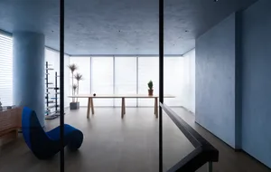 Minimalist modern office space featuring wood, glass, and concrete materials.