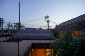 A modern residential building with a brick roof.