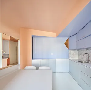 A modern minimalist kitchen with concrete finishes and a minimalist design.