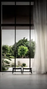 A minimalist window view showcasing a concrete floor and tree outside.