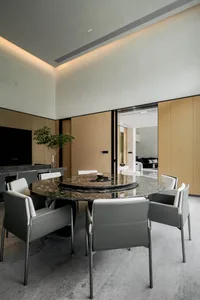 Modern dining room featuring a granite table and minimalist design.