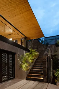 A modern entrance featuring stone and wooden elements.