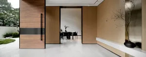 Modern entrance with wooden door and marble floor.