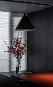 A sleek, modern office space featuring black aluminum panels, a minimalist design, and red accents.