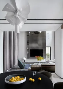 Modern minimalist living room with black and white color scheme and contemporary furniture.