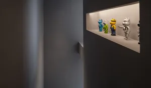 A minimalist display features various colorful toy figures.
