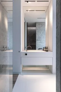 Modern bathroom with concrete walls and minimalist design elements.