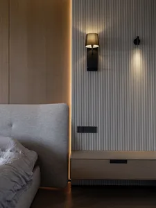 A modern bedroom with a wooden texture featuring wall-mounted lamps and a floating nightstand.