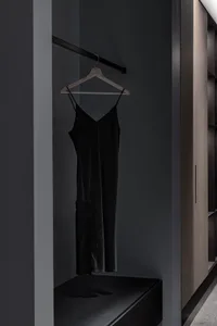 A modern clothing display featuring a black hanging garment.