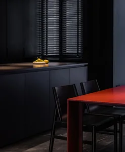 Modern kitchen with black countertops and metal finishes.
