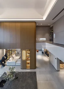 A modern living and dining space featuring wooden accents and marble surfaces.