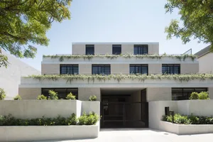 Modern residential building with brick and concrete exterior.