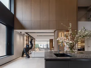 A modern residential kitchen featuring wood composite materials and a minimalist design.