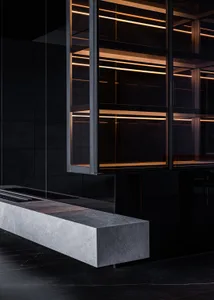 A modern industrial kitchen featuring concrete walls and a minimalist design with sleek, clean lines.