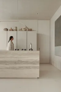 Modern kitchen interior with minimalist design, featuring marble countertops and a sleek, open layout.