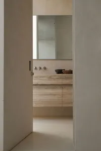 Modern bathroom featuring a wooden counter and minimalist design