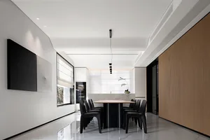 Modern dining room featuring a marbled table and black lacquered steel chairs.