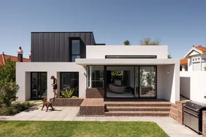 Modern house with a combination of brick, glass, and concrete materials.