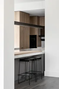 Modern kitchen interior featuring wood and marble materials.