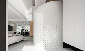 A modern living room with concrete elements and a minimalist design.