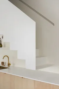 Modern minimalist interior design featuring a concrete staircase with a clean, uncluttered aesthetic.