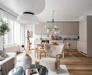 Modern, minimalist kitchen featuring open floor plan and a mix of neutral materials.