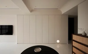 A modern minimalist white interior with sleek, flat surfaces and clean lines.