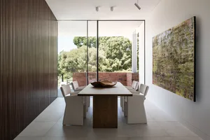 Modern dining room featuring a wooden table and fabric chairs