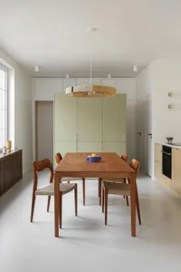 Modern kitchen and dining area featuring wood and metal furniture and fixtures.