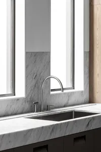 Modern kitchen featuring marble countertops and backsplash with a sleek, minimalistic design.