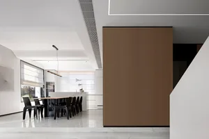 Contemporary kitchen featuring a minimalist design with wooden cabinets, marble countertops, and stainless steel appliances.