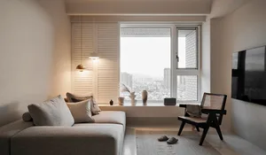 A modern minimalist living room with a sleek sofa, minimalist black chair, and a window with a cityscape view.