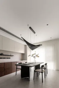 Modern kitchen interior featuring minimalist design with concrete accents. Includes sleek countertops, sleek cabinets, and ge