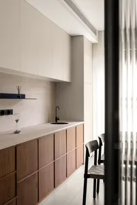 Modern kitchen featuring minimalist design with wooden cabinets and stone countertops