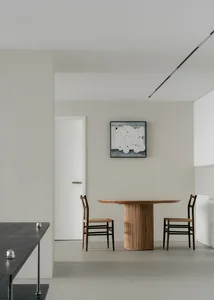 Minimalist dining room featuring a floating wood dining table.