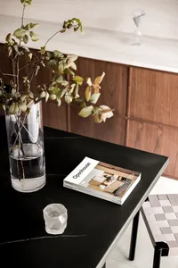A modern living space featuring marble and glass materials.