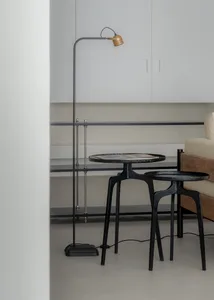 A modern living space featuring a metal floor lamp and a marble coffee table.