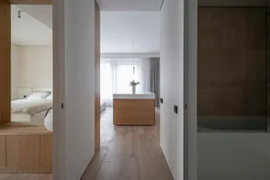 Modern residential interior featuring wood, glass, and concrete materials.