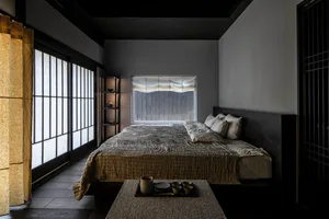 A contemporary minimalist bedroom featuring wood elements.