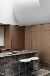 Modern kitchen with a marble countertop and sleek, minimalist design.