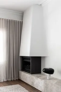Minimalist living room featuring a marble fireplace and a sleek, modern design.